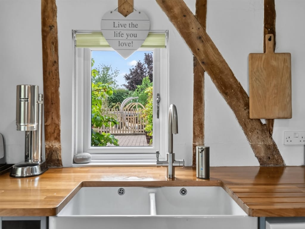 Kitchen and Breakfast Room Belfast sink, oak worktop, exposed timber beams, garden view through window, The Tithe Barn, Sisland, Norfolk