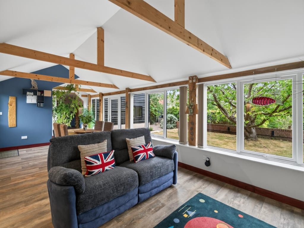 Vaulted Family Room with oak beams, wide garden-facing windows and open dining area beyond, The Tithe Barn, Sisland, Norfolk