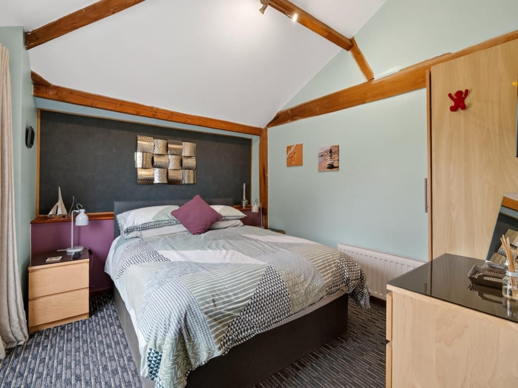 Bedroom with vaulted ceiling, exposed timber trusses, double bed and fitted wardrobe, The Tithe Barn, Sisland, Norfolk