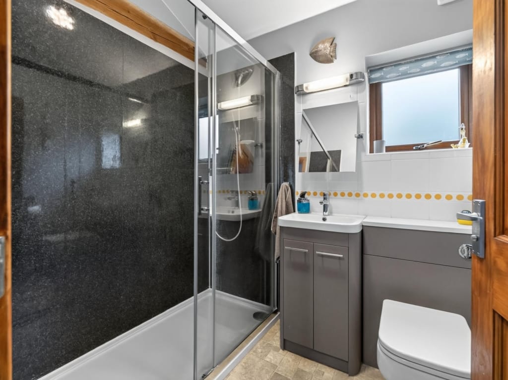 Shower room with dark stone-effect enclosure, grey vanity unit and frosted window, The Tithe Barn, Sisland, Norfolk