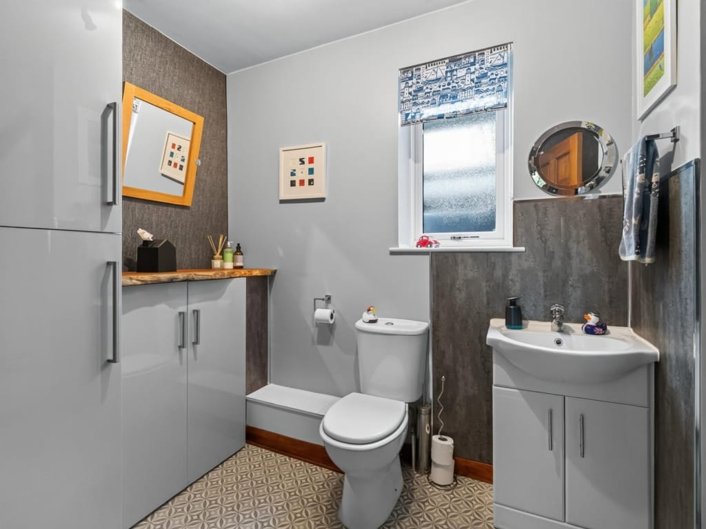 Cloakroom with patterned tile floor, gloss grey storage units, and frosted window at The Tithe Barn, Sisland, Norfolk