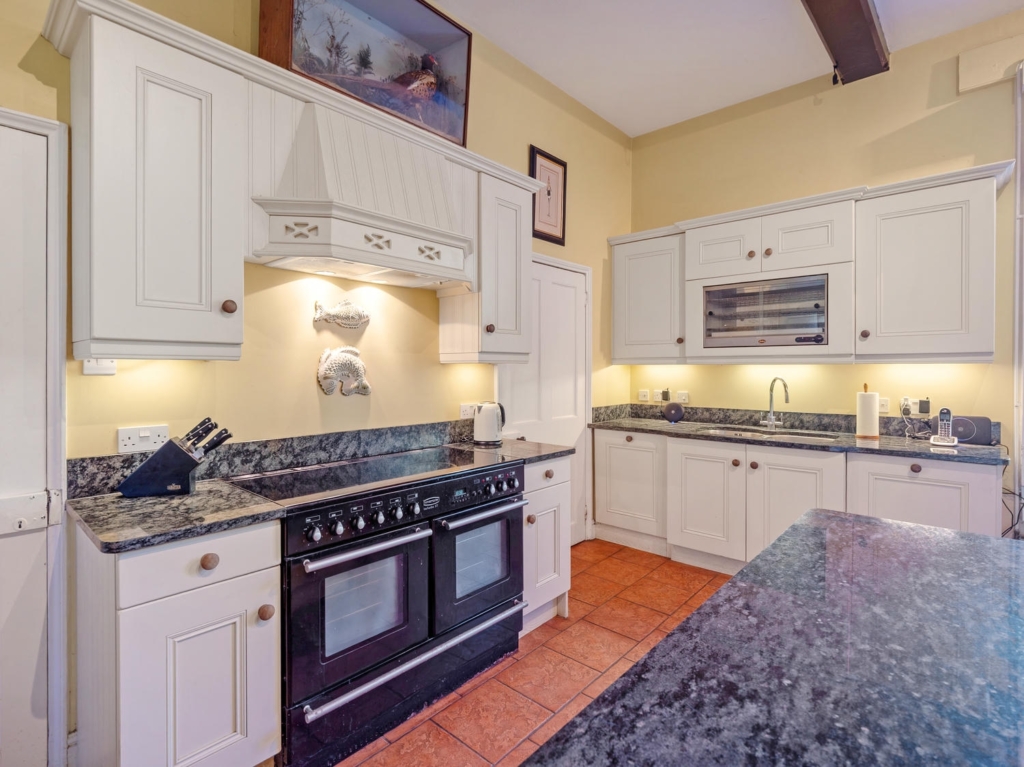 Country kitchen with range cooker, granite worktops and cream cabinetry at Loddon Hall, Norfolk