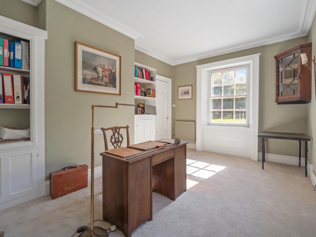 Study with built-in shelving and sash window at Loddon Hall country house, Norfolk