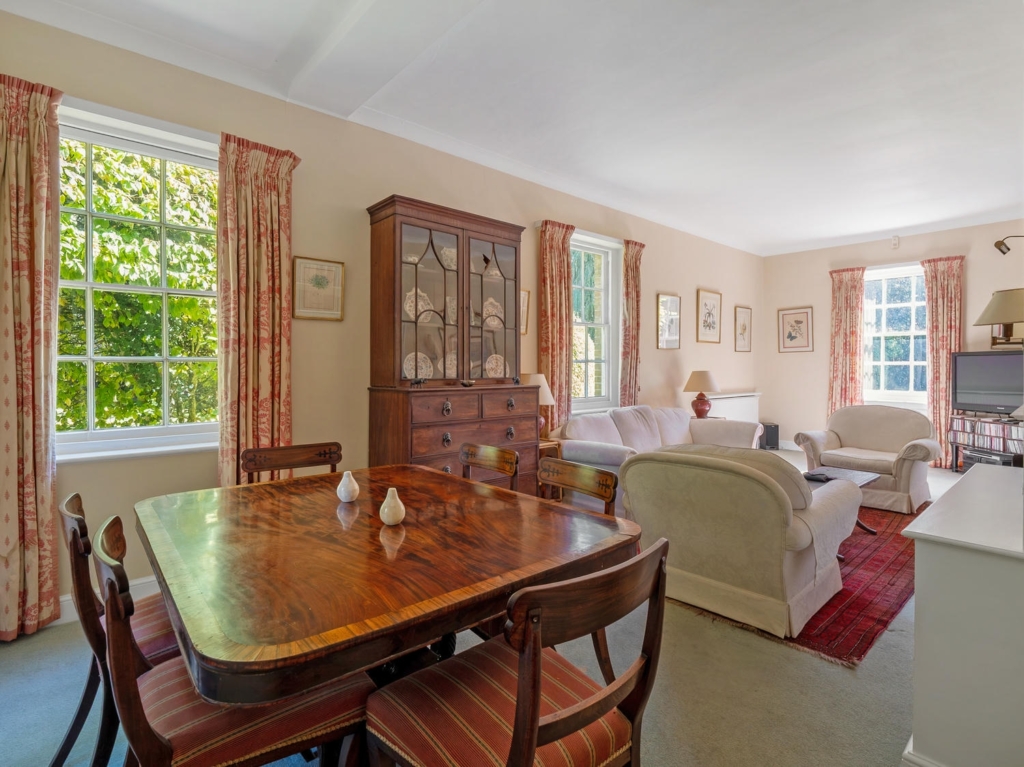 Morning room and sitting area with tall sash windows at Loddon Hall, Norfolk