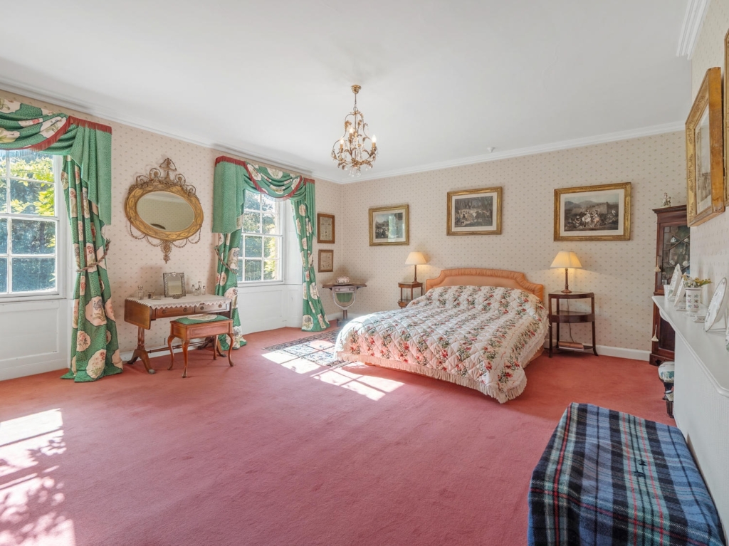 Large principal bedroom with Georgian sash windows and silk curtains at Loddon Hall