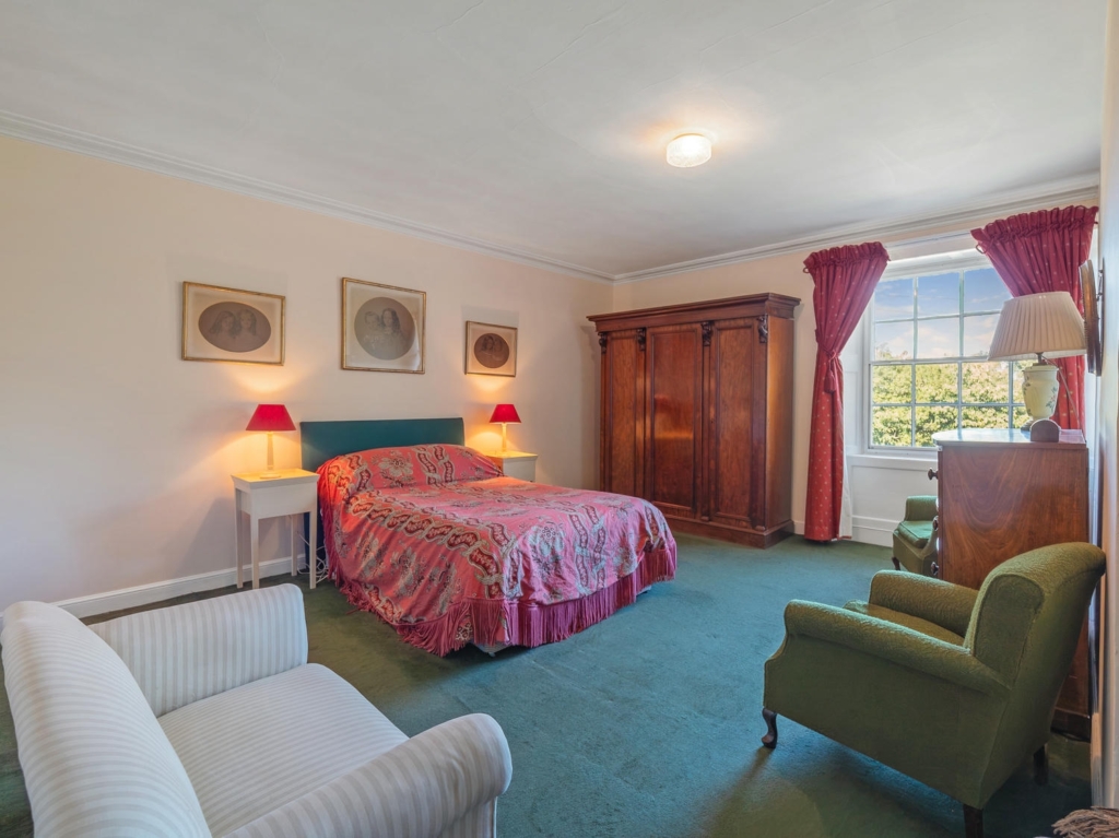 Double bedroom with sash windows and garden views at Loddon Hall, Norfolk