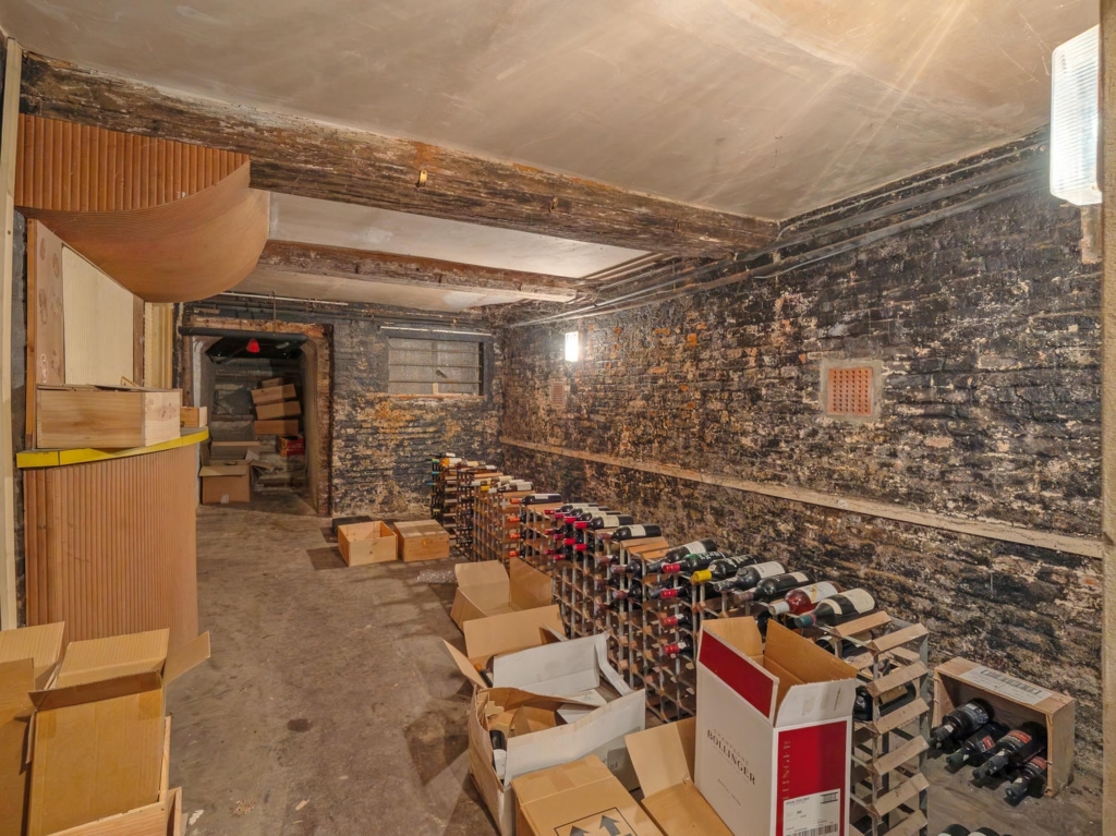 Brick-vaulted wine cellar with racking at Loddon Hall country house, Norfolk