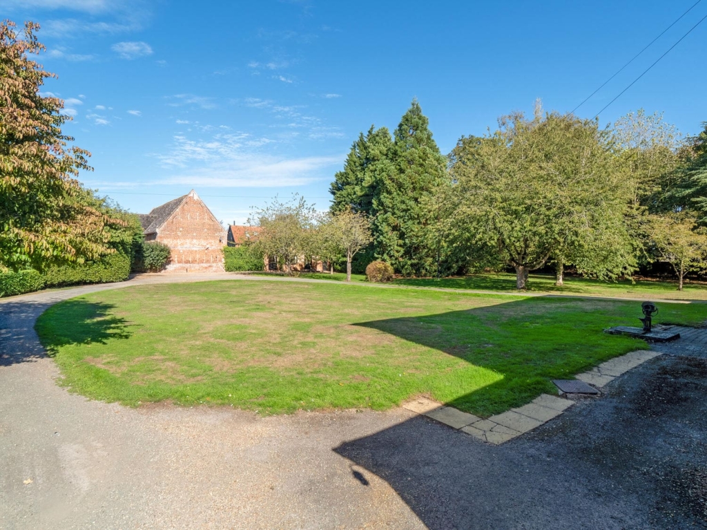 Gravel sweep, lawn and traditional barn in the grounds of Loddon Hall, Norfolk